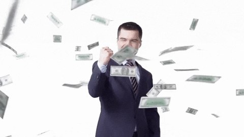 Businessman celebrating as cash falls around him